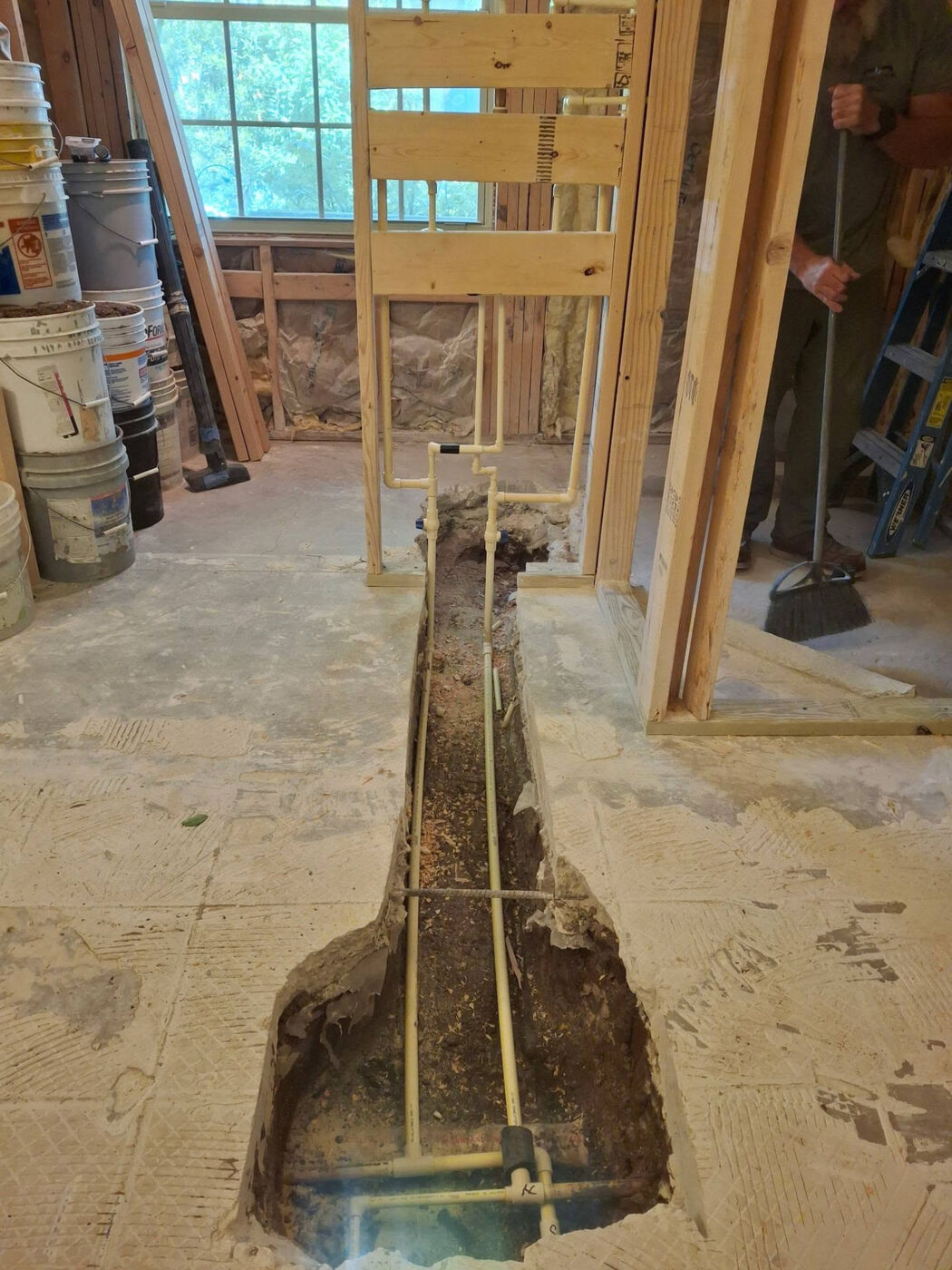A home's old failing pipes fully replaced with new drain and water lines, ending repeat leaks under the slab