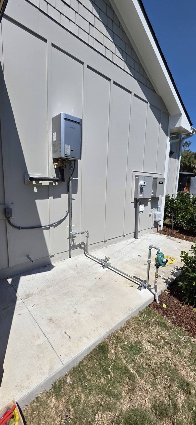 A new tankless water heater mounted outside a home, giving the family endless hot water and freeing up indoor space